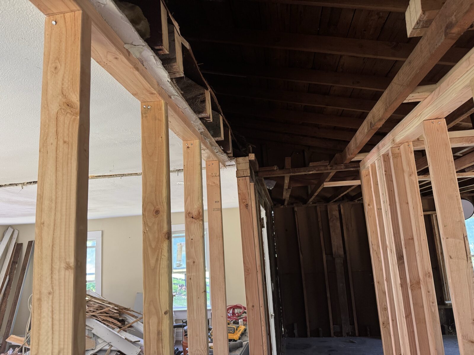 Close-up of ceiling and roof framing repair work inside a home