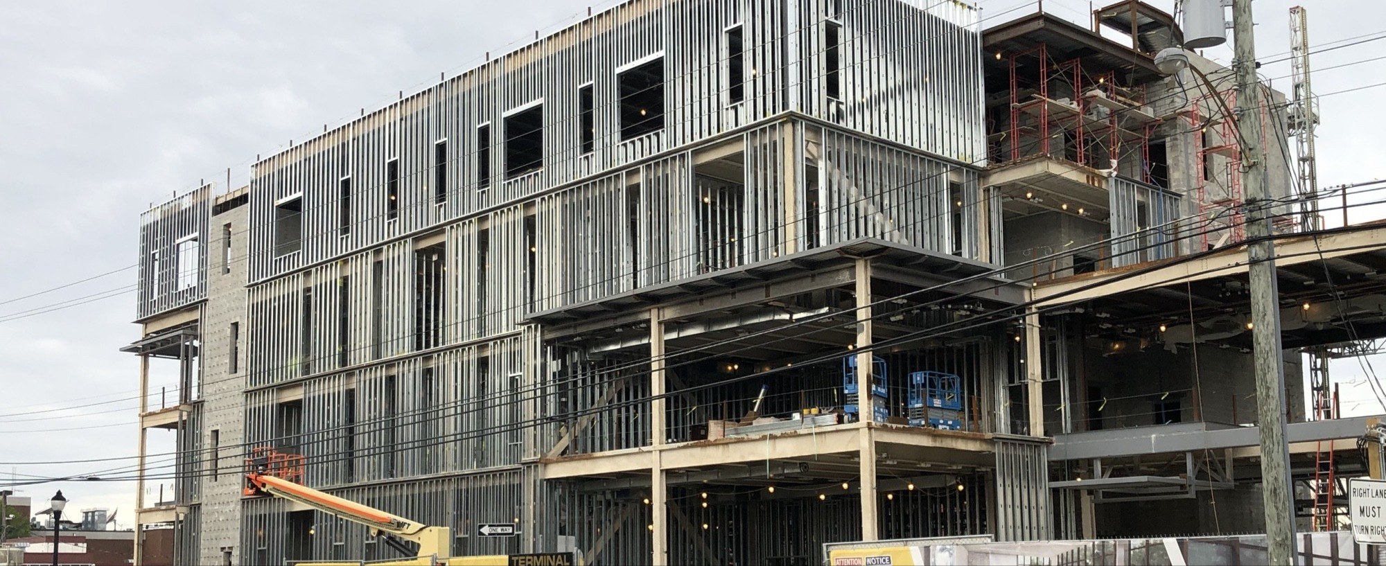 Full elevation view of a multi-story commercial steel-framed building under construction