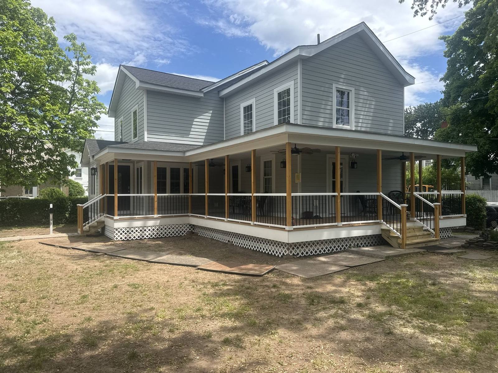 Finished covered deck with ceiling fans and seating area