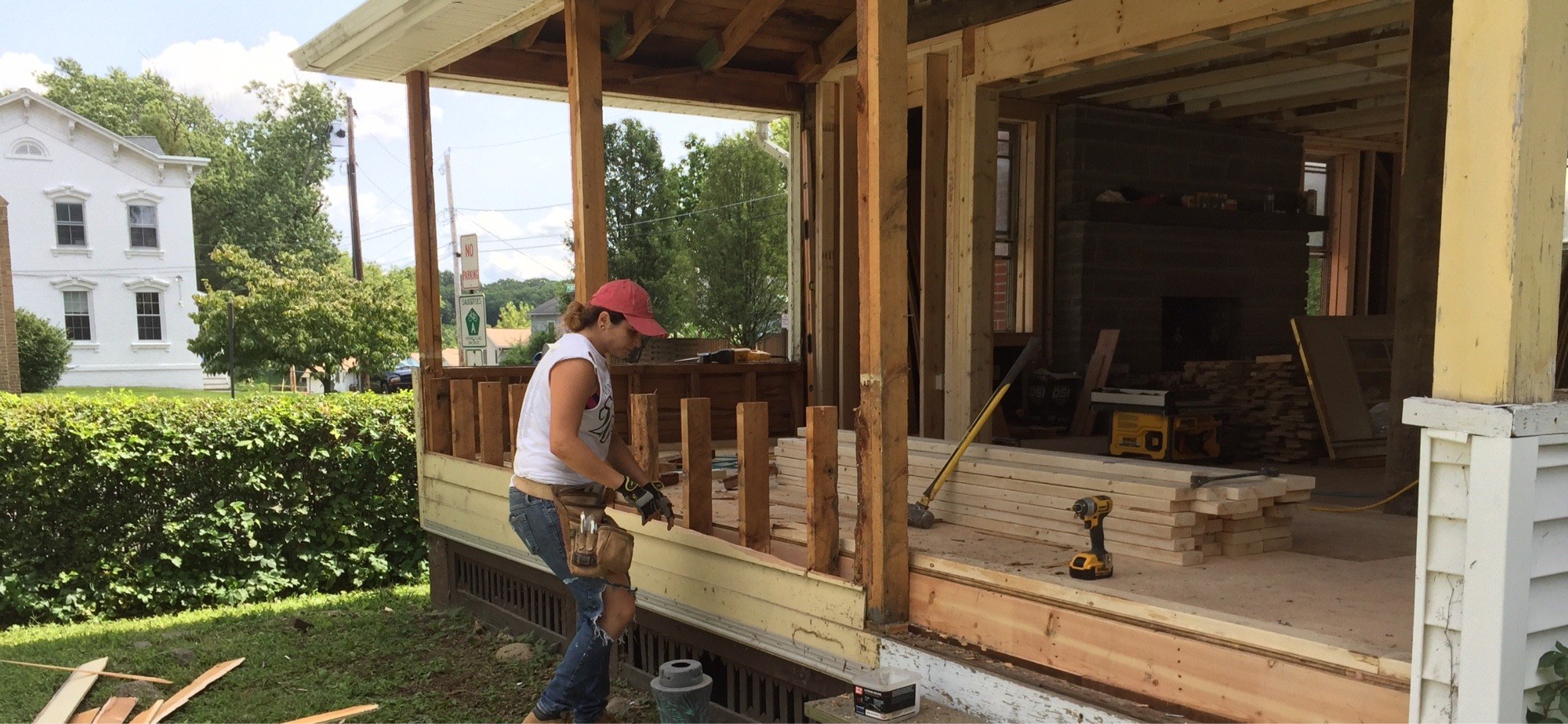 Crew member framing a porch floor during a full porch renovation project