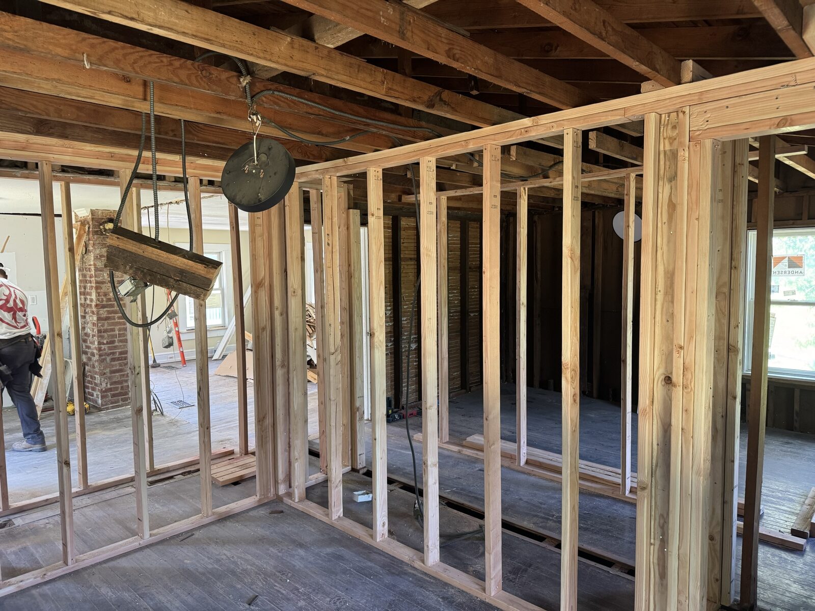 Interior framing around an original brick chimney during a home renovation